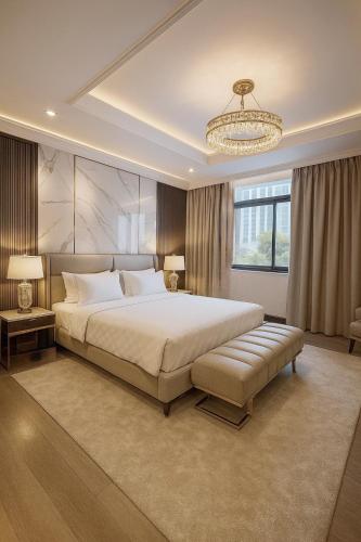 a bedroom with a large bed and a chandelier at Solumie Boutique Hotel in Bangkok