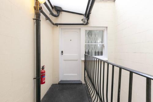 a white door with a fire hydrant on the side of a building at Magic Stay Rooms in London