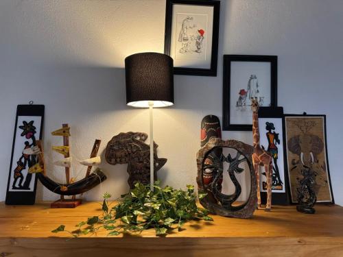 a table with a lamp and some figurines on it at Buckswood Hilltops in Stegi