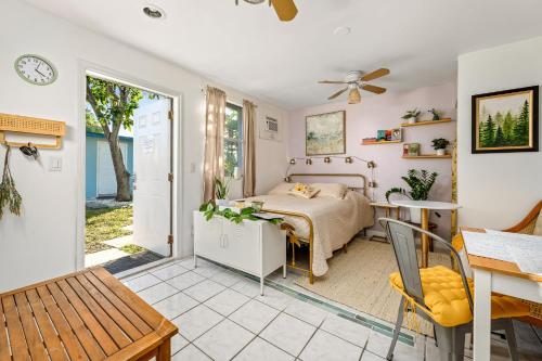 a bedroom with a bed and a table at Salthaus West Palm Beach - NEW Saltwater Pool & Spa! in West Palm Beach