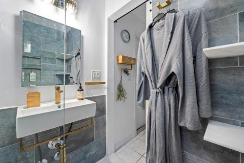 a bathroom with a sink and a mirror at Salthaus West Palm Beach - NEW Saltwater Pool & Spa! in West Palm Beach