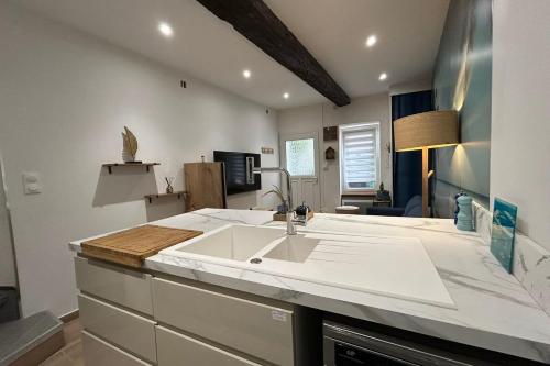 a kitchen with a sink and a living room at Bright and quiet house in Coursan in Coursan