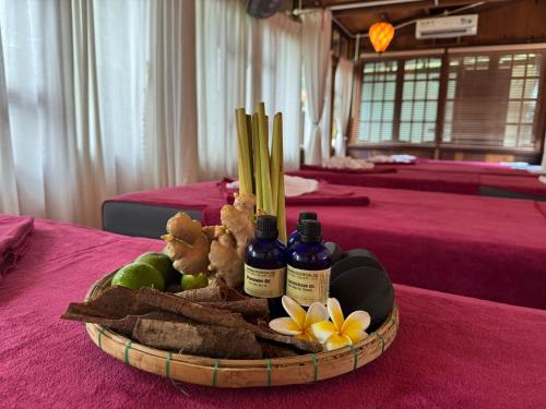 a basket of food with two bottles on a table at Hoianbang Beach Front Villa and Restaurant in An Bang