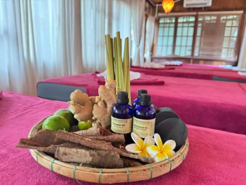 a basket of food on a table with two bottles of medicine at Hoianbang Beach Front Villa and Restaurant in An Bang