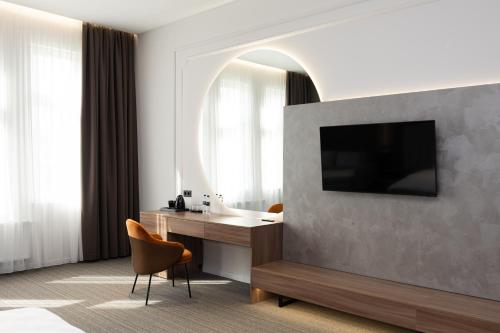 a hotel room with a desk and a mirror at Pava De Luxe in Berehove
