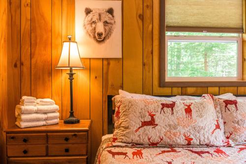 a bedroom with a bed and a window and a lamp at Lake Harmony Getaway in Lake Harmony