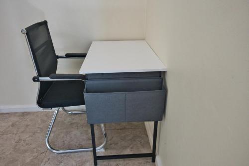 a desk and a chair in an office at The Emerald Apartments Ibex Meanwood in Lusaka