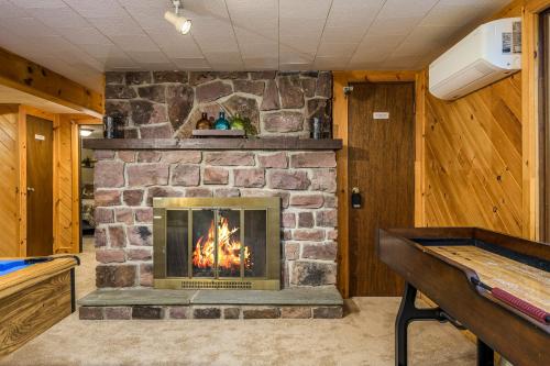 a fireplace in a room with a pool table at Lake Harmony Getaway in Lake Harmony