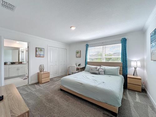a bedroom with a bed and a large window at Luxury Pool Home Near Disney Resort Access in Kissimmee