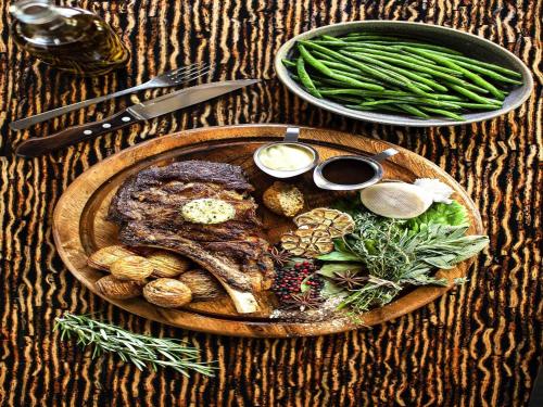 a plate of steak and vegetables on a table at ibis Wellington in Wellington