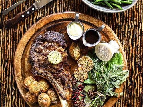 a plate of food with meat and vegetables on a table at ibis Wellington in Wellington