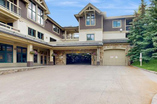 a large building with a garage and a driveway at Riverbend Lodge #001 in Breckenridge