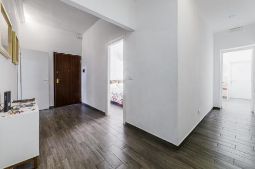 an empty room with white walls and wooden floors at Fuori Ortigia Room 2 in Siracusa