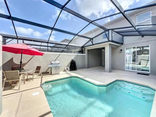 an indoor swimming pool with a glass roof at Luxury Pool Home Near Disney Resort Access in Kissimmee