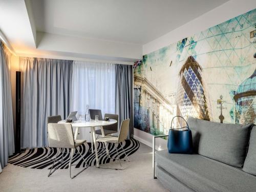 a living room with a table and a couch at Novotel London Tower Bridge in London