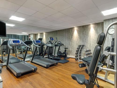 a gym with a bunch of treadmills and machines at Novotel London Tower Bridge in London