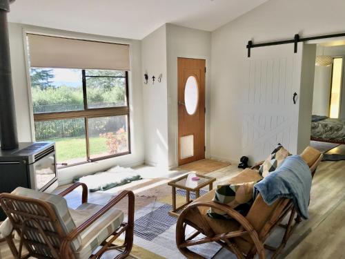 a living room with rocking chairs and a fireplace at Spacious Family Retreat on the edge of Tenterfield in Tenterfield