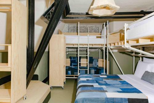 a bedroom with bunk beds and a bed in a room at JAM Ghent in Ghent