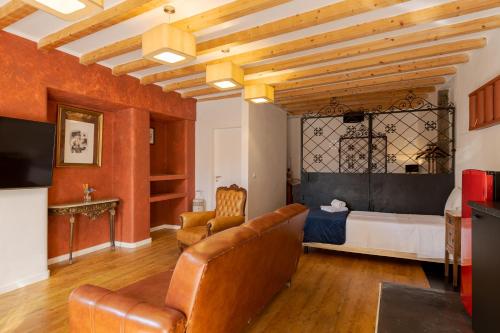 a living room with a bed and a couch at Memórias Charme Residences in Covilhã