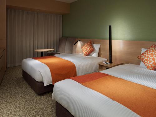 Postel nebo postele na pokoji v ubytování Mitsui Garden Hotel Kashiwa-No-Ha - Chiba