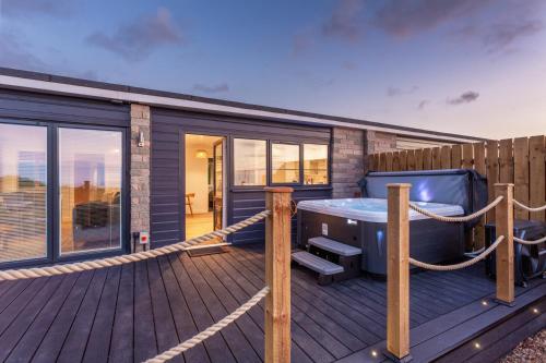 a large deck with a hot tub on a house at NDR Sea view Three bedroom Residence with private hot tub in Ilfracombe