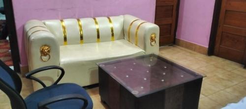 a couch and a table in a room at Indrashan Marriage Garden in Muzaffarpur