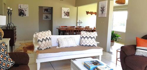 a living room with a couch and a table at The Kei Mouth Guest Lodge Collection in Kei-mouth Village