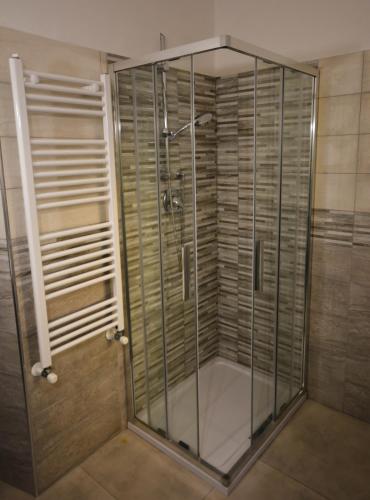 a shower with glass doors in a bathroom at La Dimora del Porto in Civitavecchia