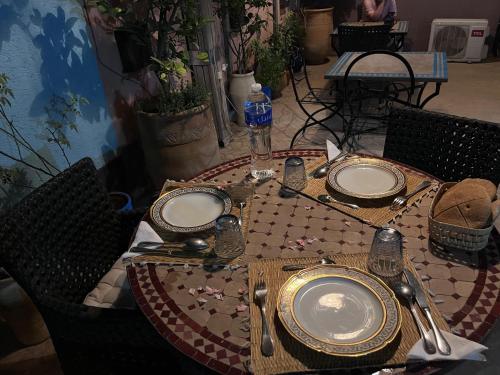 a table with plates and utensils on top at dar annee in Fès