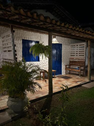 a wooden patio with a bench and a table at Chalés XIÉ in São Miguel dos Milagres