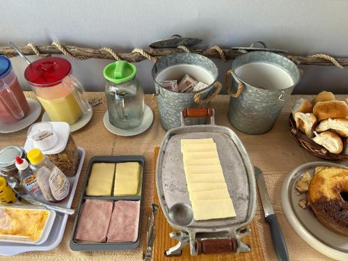 a table topped with cheese and other food items at Chalés XIÉ in São Miguel dos Milagres