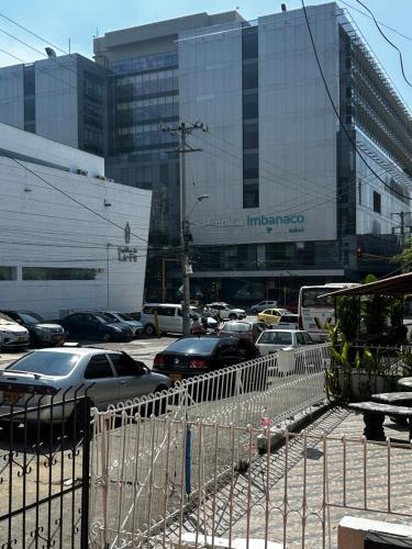 a bunch of cars parked in a parking lot with buildings at Cozy private room in Cali's heart in Cali