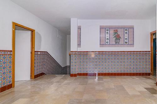 an empty room with a staircase and a tile floor at Casa de las Nieves in Granada