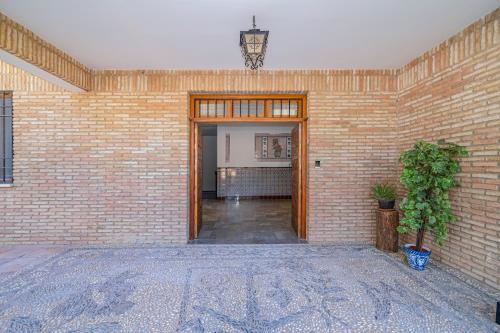 an empty room with a brick wall at Casa de las Nieves in Granada