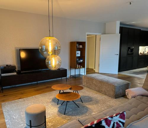 a living room with a couch and two tables at 180qm Penthouse mit Sonnenterrasse in Rostock