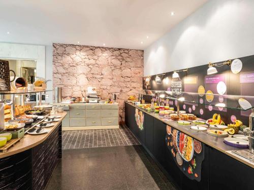 a large kitchen with many dishes on the counters at Mercure Hotel & Residenz Berlin Checkpoint Charlie in Berlin