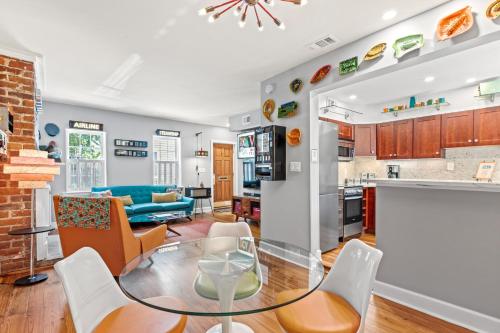 a kitchen and living room with a glass table and chairs at Jet Setter in Savannah