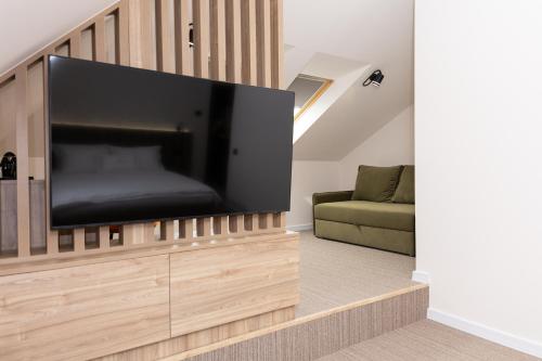 a living room with a large flat screen tv at Pava De Luxe in Berehove