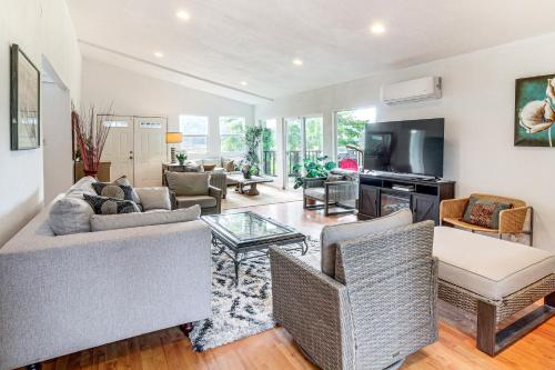 a living room with a couch and a table at 2 Mi to Downtown Coos Bay Home with Deck, Fire Pits in Coos Bay