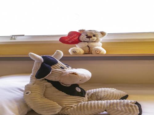 two stuffed animals are sitting on a shelf at ibis Sao Jose dos Campos Dutra in São José dos Campos
