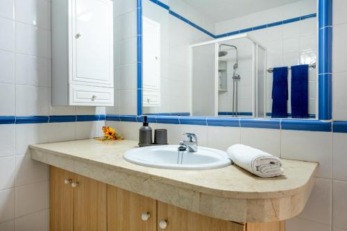 a bathroom with a sink and a mirror at Tranquilidad frente al mar by CABANA Rentals in Arona
