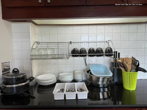 a kitchen with a counter with pots and pans at Angel Pool Villa Phuket - SHA Extra Plus in Phuket Town