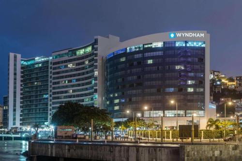 a large building with a sign on it at night at Vista al faro Habitacion doble in Guayaquil