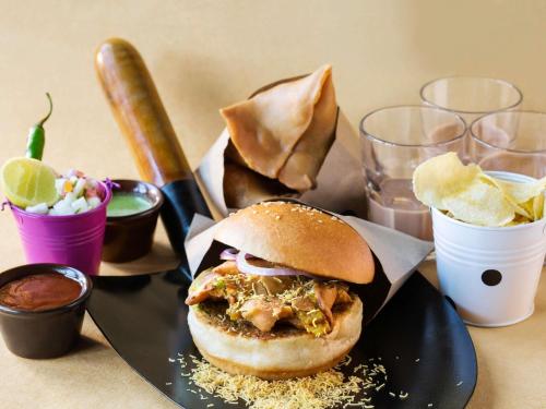 a sandwich on a plate with chips and drinks at Ibis Warszawa Ostrobramska in Warsaw