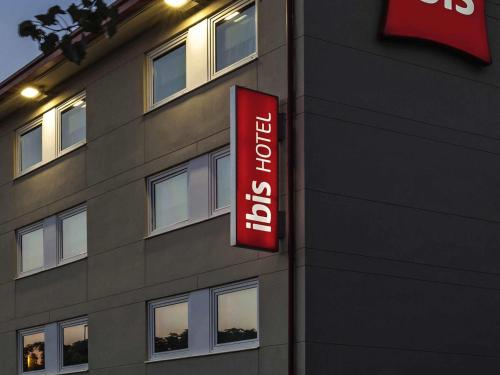 a hotel sign on the side of a building at Ibis Cornella in Cornellà de Llobregat