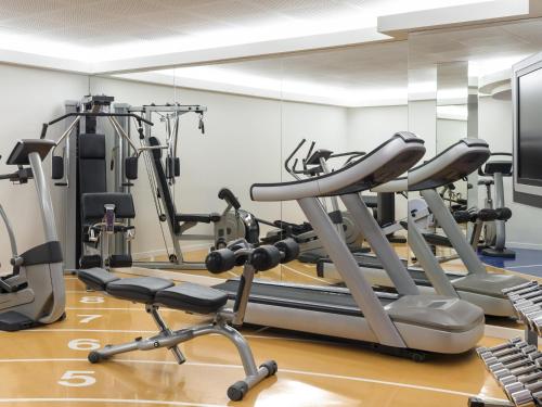 a gym with tread machines and a mirror at Novotel Genève Centre in Geneva