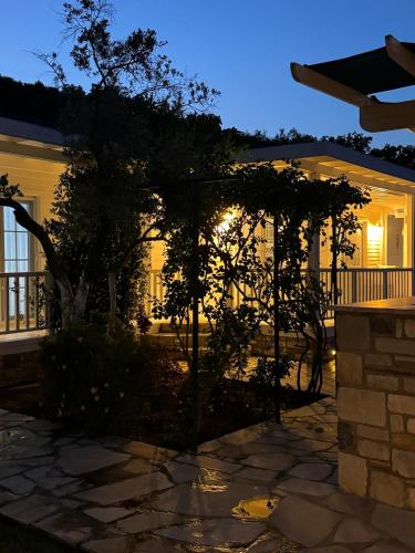 a house with a tree in the yard at night at Casa del Olivia in Seferihisar