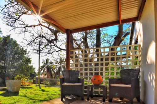 a gazebo with two chairs and a table at The Kei Mouth Guest Lodge Collection in Kei-mouth Village