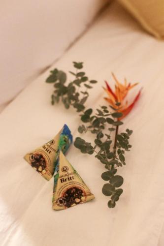 two pieces of food on a white plate with a flower at Sumba Lodge in Manuel Antonio