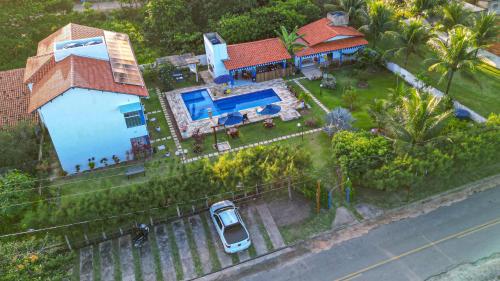 an aerial view of a house with a swimming pool at Chalés Casuarinas in Japaratinga